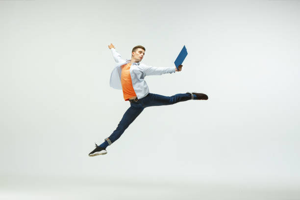 istock Man working at office and jumping isolated on studio background 1156660007