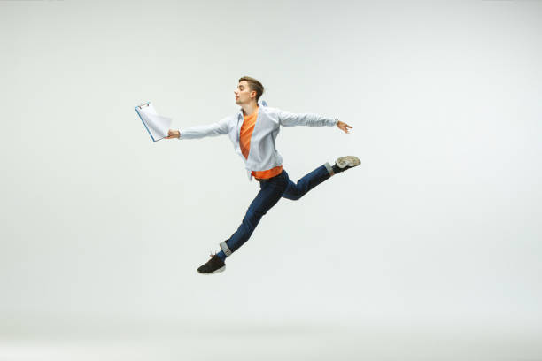 istock Man working at office and jumping isolated on studio background 1156660009