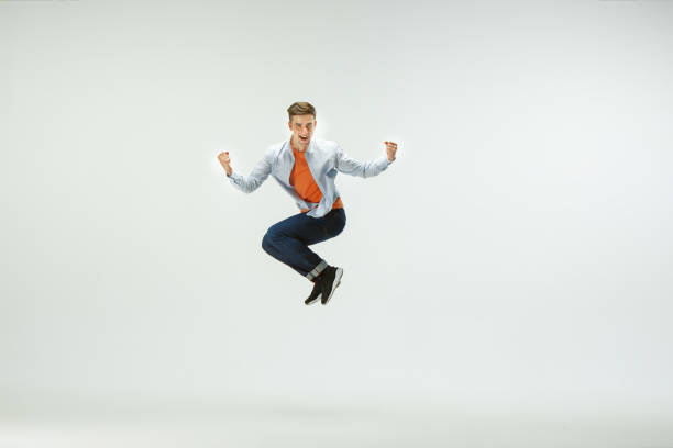 istock Man working at office and jumping isolated on studio background 1156660015