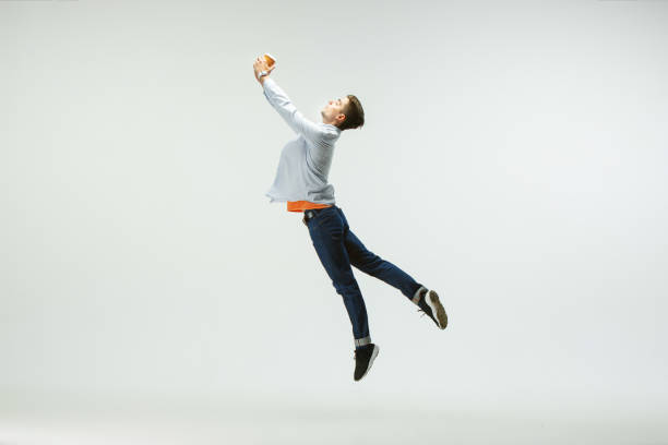 istock Man working at office and jumping isolated on studio background 1156660017