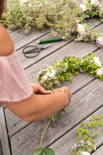 istock Woman making a flower crown on midsummer in Sweden 1156660311