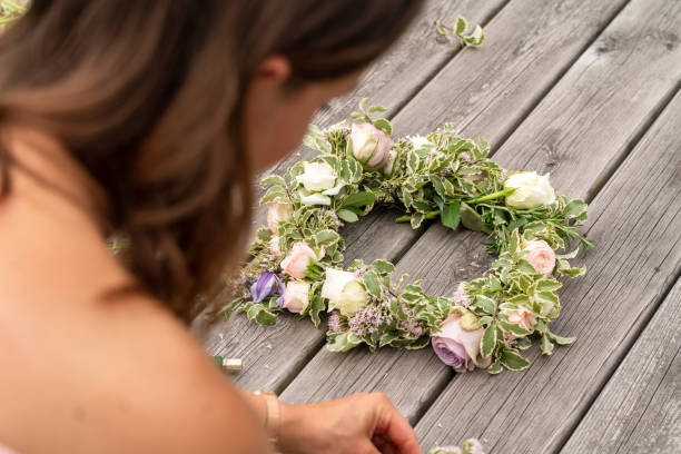 istock Woman making a flower crown on midsummer in Sweden 1156660334
