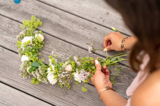 istock Woman making a flower crown on midsummer in Sweden 1156660335