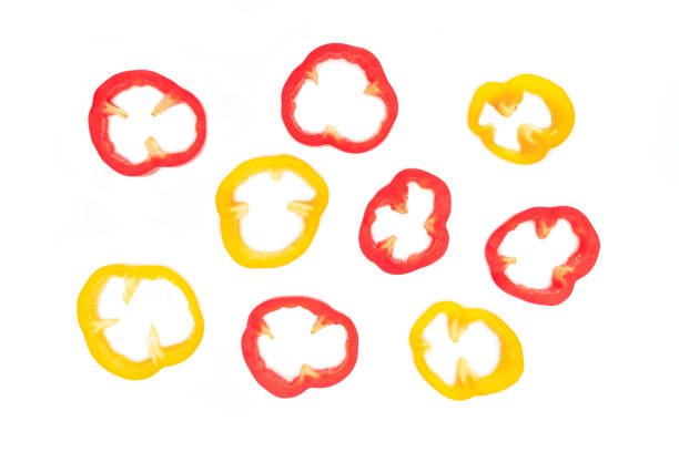 istock red and yellow bell pepper cut into pieces on white background, top view. 1156661102