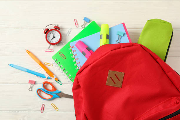 istock Flat lay composition with backpack and school supplies on white wooden background 1156661337