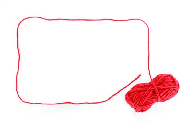 Photo of border yarn color red on white background.