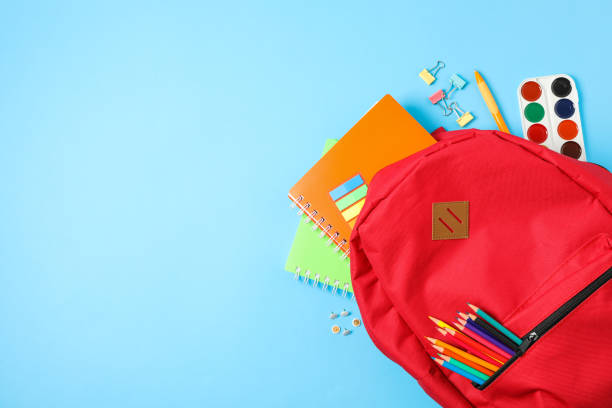 istock Flat lay composition with backpack and school supplies on color background 1156662375