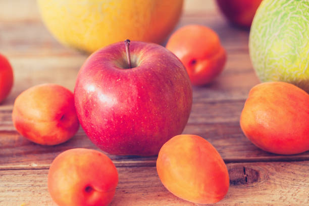 istock Fresh fruits at table, close-up, apples with apricot 1156662400