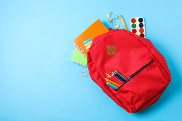 istock Flat lay composition with backpack and school supplies on color background 1156662451