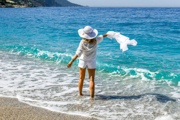 istock Woman walking on the beach. 1156662510