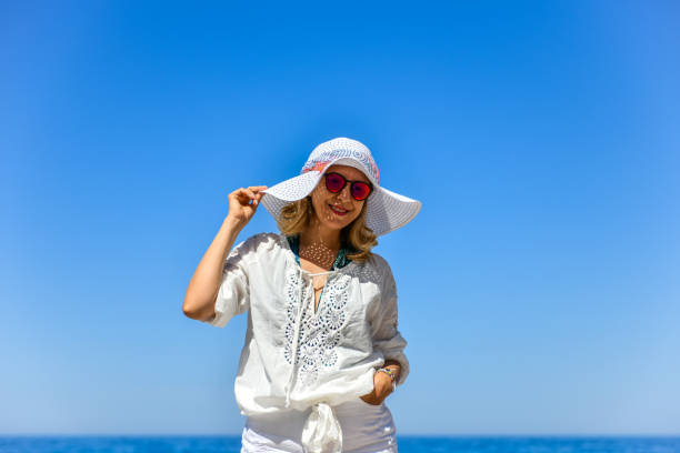istock Woman walking on the beach. 1156666602