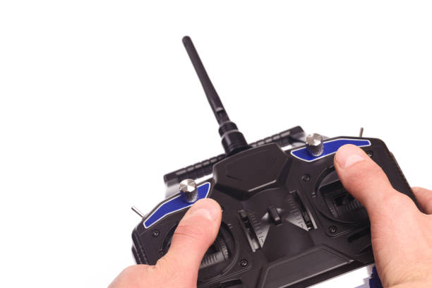 istock mans hands holding remote control with joysticks and antenna  isolated on white background - image 1156668036