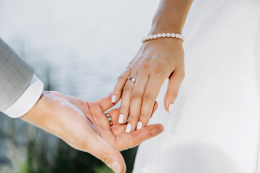 Married couple holding hands. Close up image.