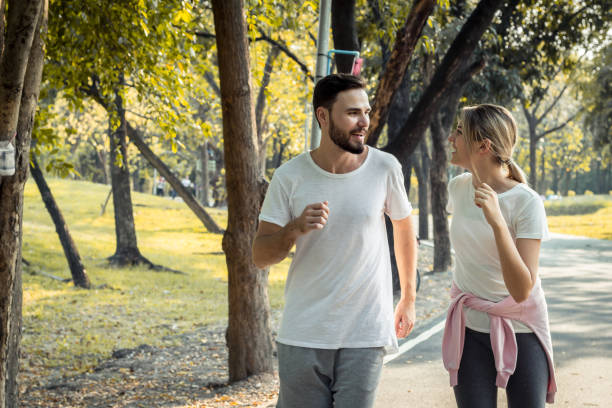 istock Couples exercise at the park in the morning. 1156669103