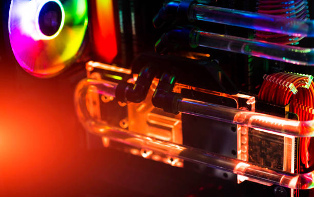 Inside a high performance computer. Computer circuit board and CPU cooling fans illuminated by internal LEDs inside a server class computer. Inside a high performance computer. Computer circuit board and CPU cooling fans illuminated by internal LEDs inside a server class computer. overclock stock pictures, royalty-free photos & images