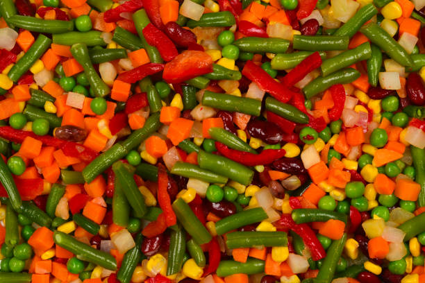 istock Sliced vegetables, corn, beans, peas, carrots, sweet peppers background. 1156671323