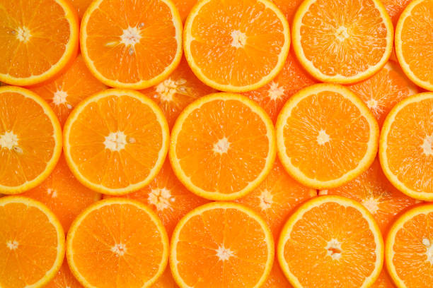 istock Slices of oranges as a background, top view. 1156671331