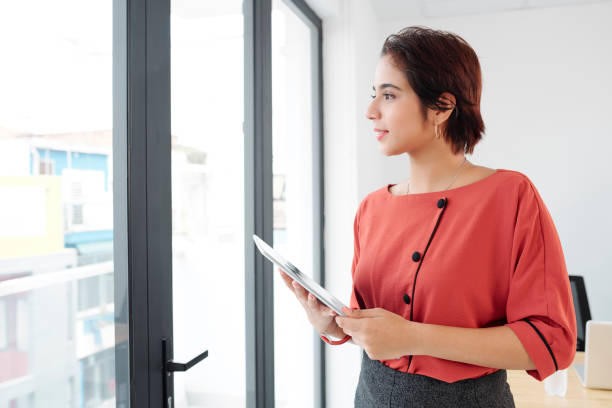 istock Businesswoman with tablet pc standing at office 1156672773
