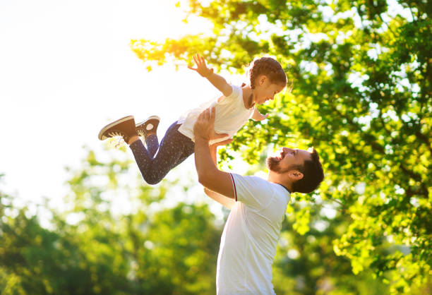 concept of father's day! happy family dad and child daughter    in nature - vacations two generation family caucasian friendship imagens e fotografias de stock