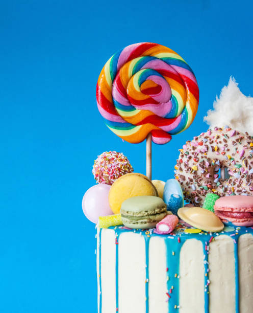 Colorful candy drip cake, blue background, right sided, close-up