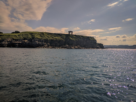 comb of the winds of Gijón seen from the sea on a sunny afternoon