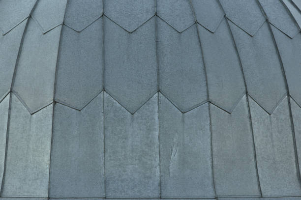 Gray tile roof floor background. Closeup roofing texture pattern. Materials to build a house for sun and rain protection. White backdrop with top rays light.