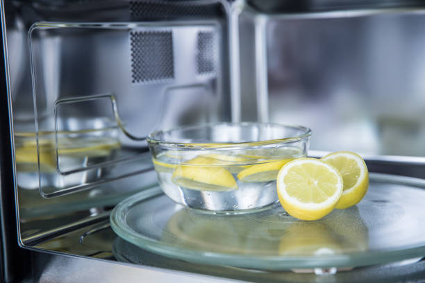 A method of cleaning in a microwave oven with water and lemon stock photo