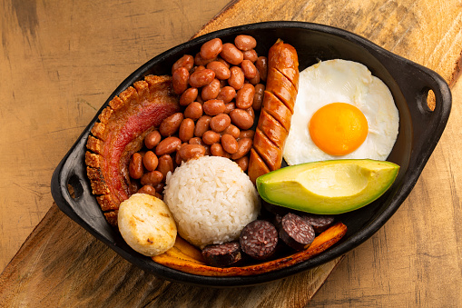 Bandeja paisa, typical dish at the Antioqueña region of Colombia. It consists of chicharrón (fried pork belly), black pudding, sausage, arepa, beans, fried plantain, avocado egg, and rice