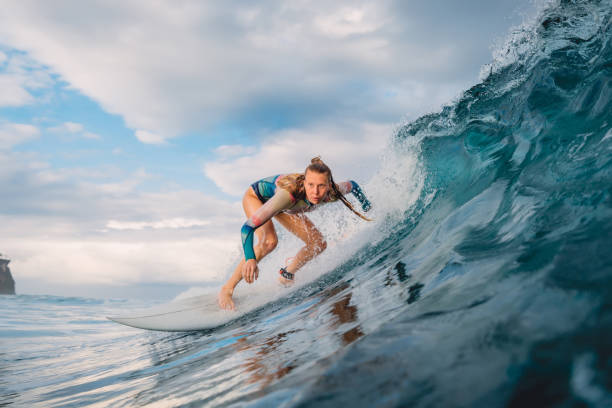 hermosa chica surfista en tabla de surf. mujer en el océano durante el surf. surfista y ola de barril - bikini surfboard women surfing fotografías e imágenes de stock