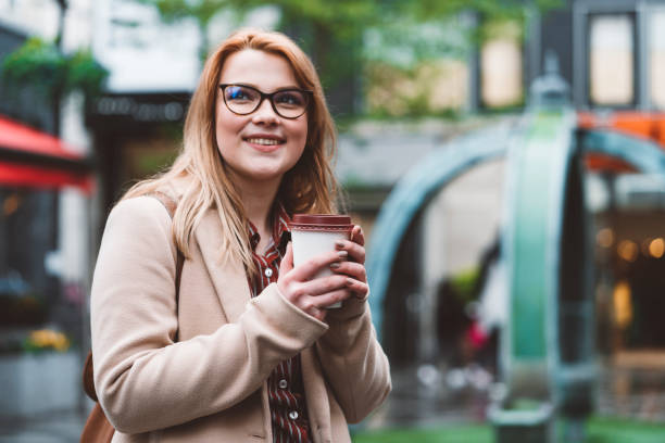 istock Happy young woman drinking her coffee 1156695042