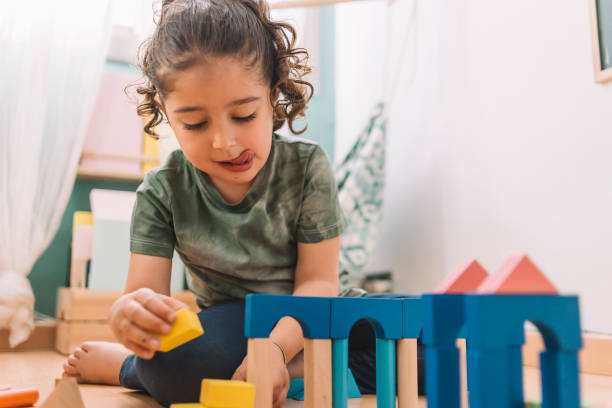 istock girl playing constructions with wooden blocks 1156696163