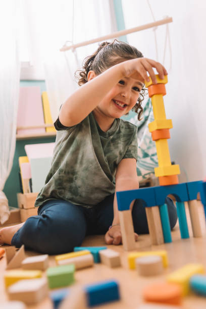 istock happy little girl playing with building blocks 1156696175