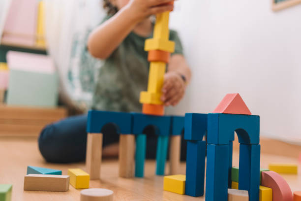 istock colorful wooden building blocks with child playing 1156696190