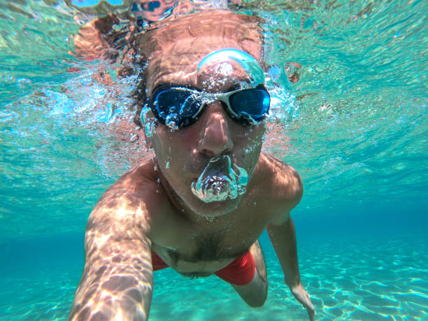 istock Underwater photo of active man swimming 1156696355