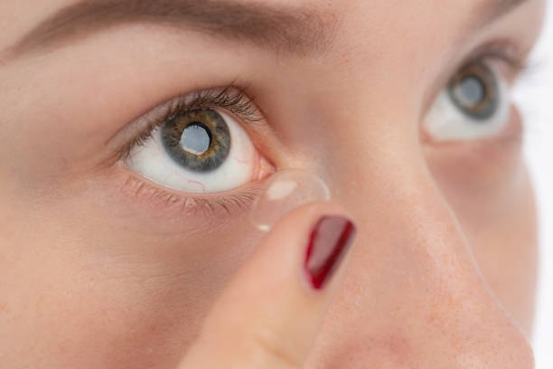istock A woman inserts a contact lens with her finger 1156697240