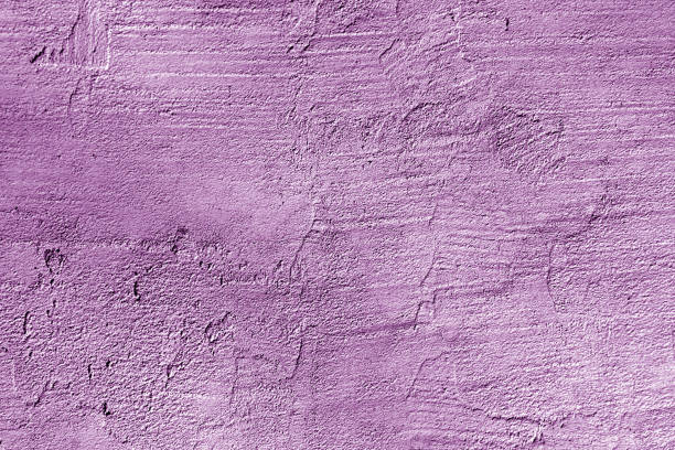 istock craked weathered cement wall texture in purple color. 1156697688