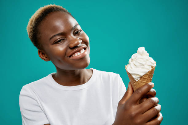 istock Young woman keeping tasty ice cream and looking at camera 1156698043