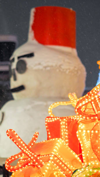 istock snows man and snow fall with gift close up 1156701202