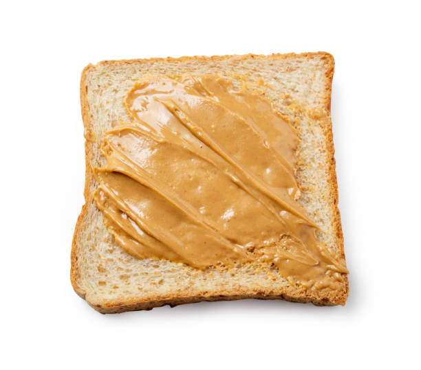 istock peanut butter on slices toast bread isolated on white background, File contains a clipping path. 1156703363