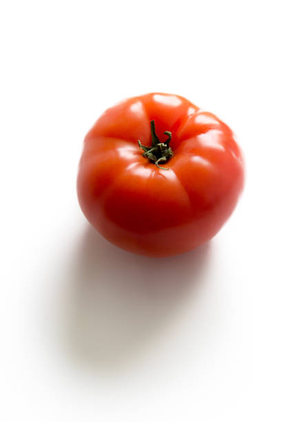 istock A ripe fresh red tomato isolated on white background 1156703483