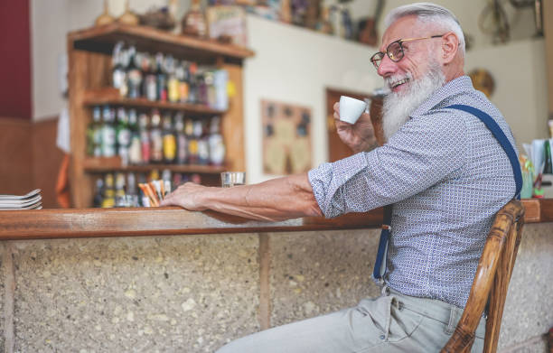 istock Happy senior man drinking coffee inside vintage bar - Fashion old guy having fun doing breakfast - Joyful elderly lifestyle concept - Focus on his face 1156703516