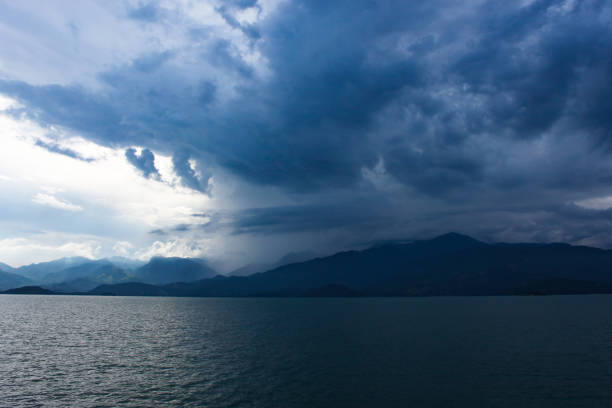 istock Majestic sky with sunlight over blue mountains at a summer beach coast. 1156707496