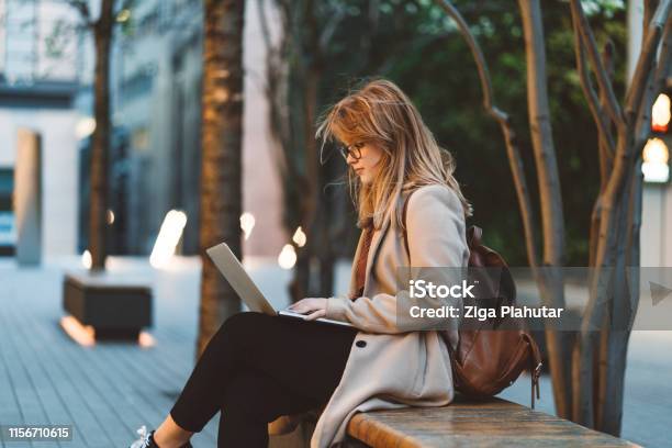 Woman Using Laptop On A Bench Stock Photo - Download Image Now - Outdoors, Student, Laptop