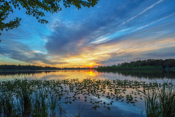 istock Sunset over Calm Lake Water 1156711391