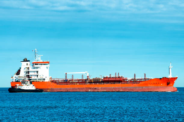 istock Container ship with tugboats entering the harbor 1156714668