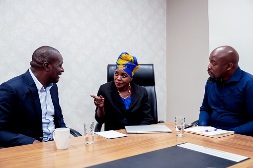 Business, Corporate Business, Portrait - Business meeting in progress at boardroom attended by the female chairperson and the other business associates