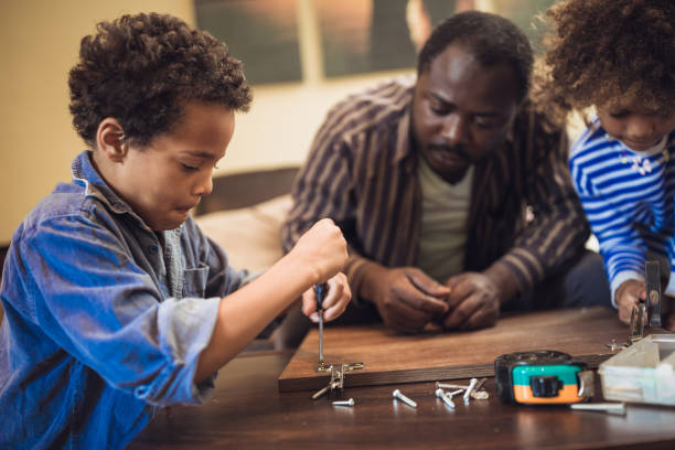 istock Father and his children doing some DIY work at home 1156715171