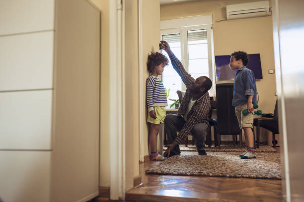 istock Father checking height of his children 1156715186