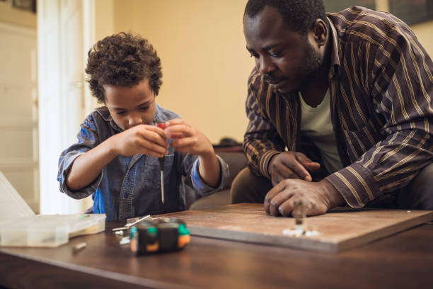 istock Father and his children doing some DIY work at home 1156715196
