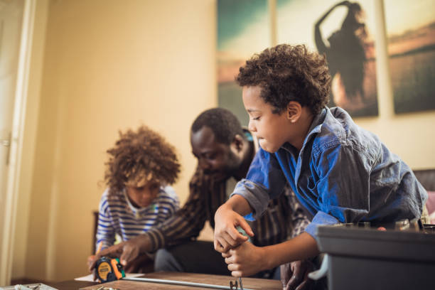 istock Father and his children doing some DIY work at home 1156715197